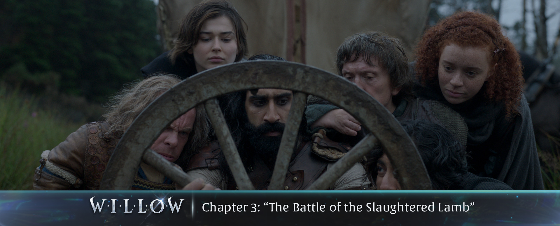 The crew looking at their broken wagon wheel